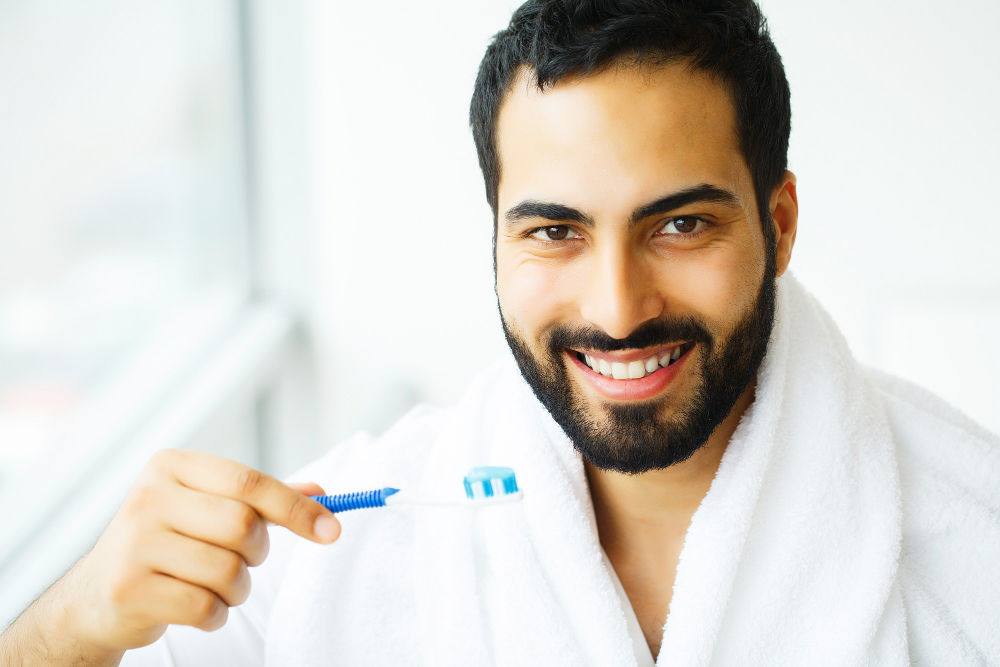 Worcester Dentist | Man holding toothbrush.